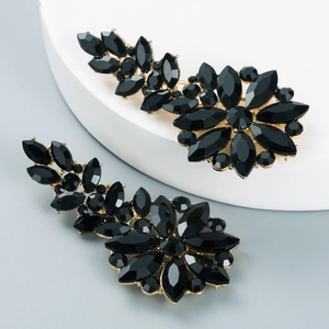 Detailed macro view of black crystal floral earrings with elegant golden alloy base