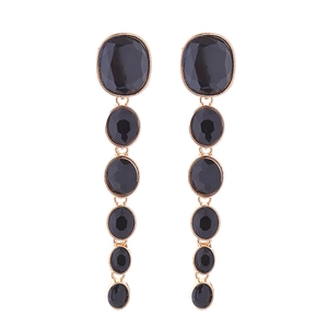 Detailed close-up of long multilayered black faceted glass drop earrings with gold frames