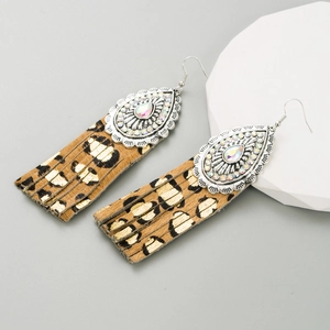 Detail view of teardrop crystal inlay and leopard print leather fringe on vintage earrings