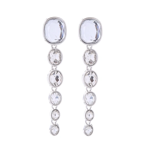 Macro view of long multi-layer silver fringe earrings with clear crystal drop details
