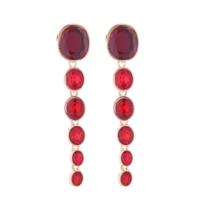 Close-up of long multilayer drop earrings with red crystal stones and gold plating