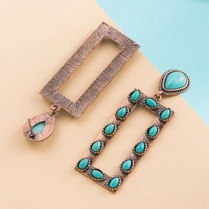 Detail of vintage bronze rectangle earrings featuring inlaid turquoise teardrop stones
