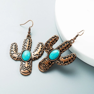 Detailed close-up of retro cactus drop earrings with turquoise inlay and bronze finish