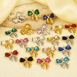 Detailed macro view of multi-color bow crystal pendants with gold and silver bases