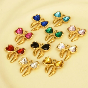 Macro detail of 304 stainless steel bow charms with colorful heart-shaped rhinestones