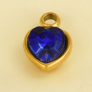 Macro view of heart-shaped blue glass stone pendant with gold-plated stainless steel setting
