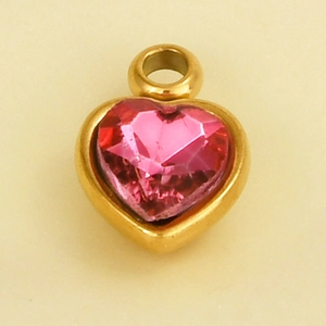 Detail view of a 304 stainless steel heart pendant with a pink crystal in a gold frame