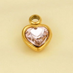 Detail of a pink heart-shaped crystal pendant with a gold-plated stainless steel frame