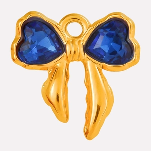 Detail of golden bow pendant with heart-shaped blue crystals and a round top hanging ring
