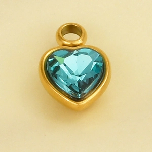 Detail showing a heart-shaped blue crystal pendant with gold-plated stainless steel frame