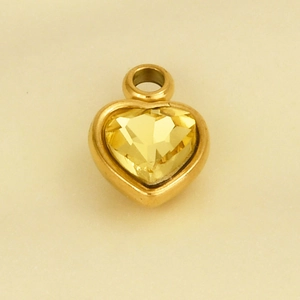 Detail of a gold heart pendant with a yellow crystal and 304 stainless steel frame