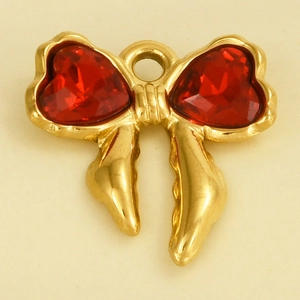 Macro view of gold bow pendant featuring two deep red heart-shaped gemstones for DIY jewelry