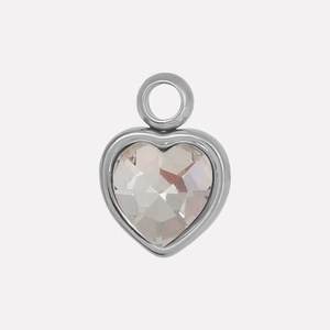Macro shot of silver heart pendant featuring a clear faceted glass crystal and metal frame