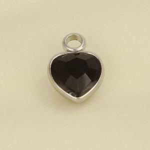 Detailed view of faceted heart pendant in silver metal frame for jewelry making
