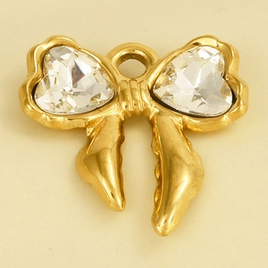 Detail of golden bow pendant with two heart-shaped clear crystals and a connector loop