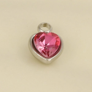 Macro shot of heart-shaped pink zircon pendant with silver stainless steel setting