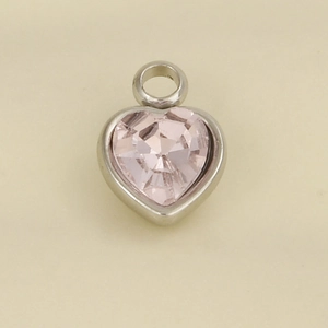 Macro detail of heart-shaped pendant with pink gemstone and 304 stainless steel frame