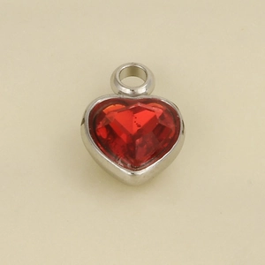 Macro shot of 304 stainless steel heart pendant with red faceted glass stone