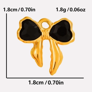 Detail showing dimensions of golden bow pendant with black heart-shaped inlay charms