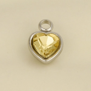 Detailed macro view of heart-shaped 304 stainless steel pendant with yellow crystal stone