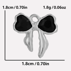 Detail view of 304 stainless steel bow pendant with black heart-shaped glass stones