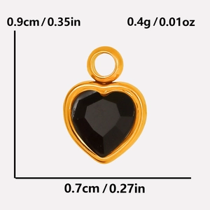 Macro detail of a 0.9cm heart pendant with black faceted stone and golden frame