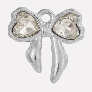 Macro detail of silver bow pendant featuring heart-shaped crystals and hanging loop