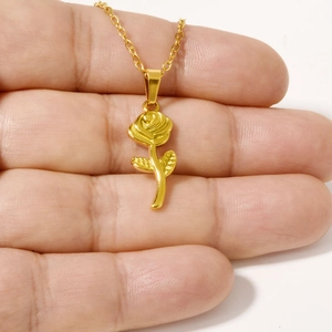 Polished 304 stainless steel rose pendant necklace in golden finish held in hand
