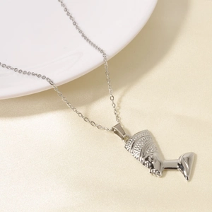 Detailed close-up of Queen Nefertiti profile pendant in polished silver stainless steel