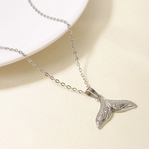 Close-up of a 304 stainless steel silver fishtail pendant with retro textured engraving