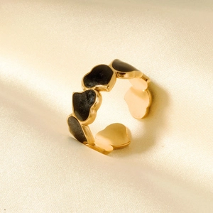 Close-up of gold stainless steel open ring with black enamel heart-shaped pattern