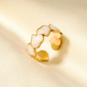 Detail of vintage French heart ring in gold finish on elegant yellow silk fabric