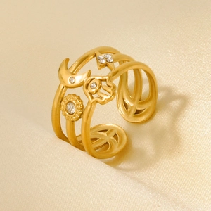 Detail of 18k gold plated stainless steel ring featuring Hamsa Hand and celestial charms