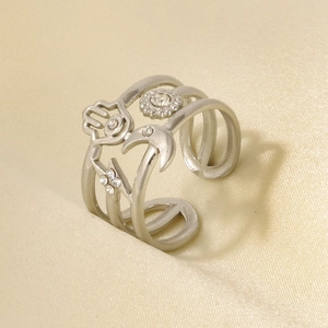 Macro shot of silver adjustable ring with Fatima hand and moon symbols on satin fabric