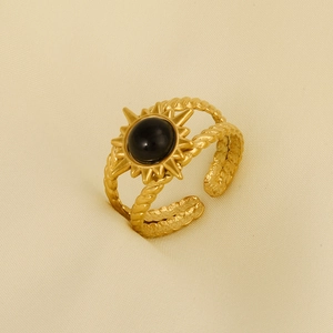 Detail of vintage 304 stainless steel ring with black stone and sunburst design