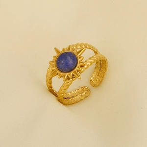 Detailed macro view of retro 304 stainless steel sun ring with blue stone and gold finish