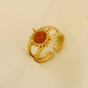 Detail of vintage gold sun ring with red stone and adjustable twisted rope band