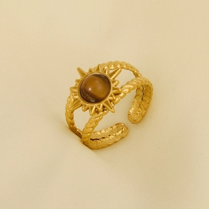Detailed macro view of vintage gold sun ring with tiger eye stone and twisted band