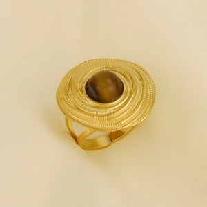 Macro detail of gold 304 stainless steel ring with tiger eye stone and spiral texture