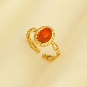 Macro detail of vintage gold 304 stainless steel ring with oval orange gemstone