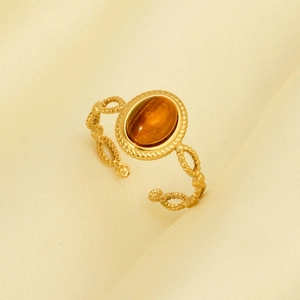 Close-up of gold stainless steel ring featuring oval tiger eye stone and beaded band