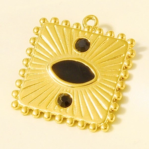 Macro view of vintage style gold-plated stainless steel rectangular pendant with black inlay