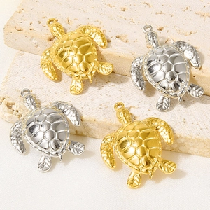 Detail of gold and silver sea turtle pendants for DIY necklaces with textured shells
