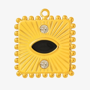 Detail of square gold evil eye pendant with black enamel and radiant sunburst engraving