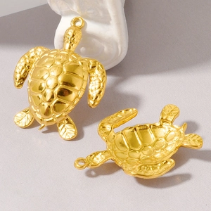 Macro shot of gold stainless steel turtle pendants with detailed shell texture and back view