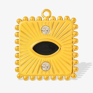 Detail showing vintage gold-plated square pendant with black enamel and radiant texture