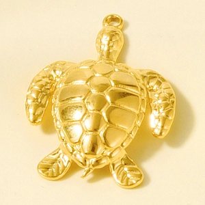 Detailed macro view of a golden sea turtle pendant featuring textured shell and hanging loop