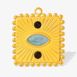 Macro detail of vintage gold square pendant with blue stone and bead trim edges