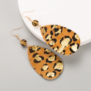 Macro detail of leopard print faux leather teardrop earrings with gold foil accents