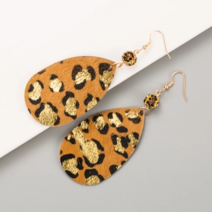 Detail of teardrop leopard print leather earrings with gold hooks and rhinestone accents